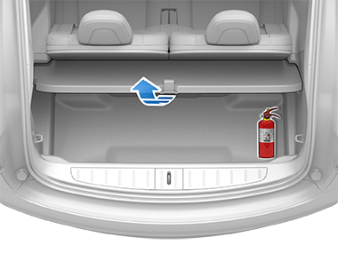 Rear trunk with fire extinguisher and blue arrow pointing up from cargo cover