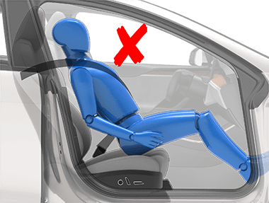 Person sitting in car seat incorrectly with hips at the front of the seat cushion