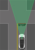 Vehicle approaching a four way intersection and stops at a road marking