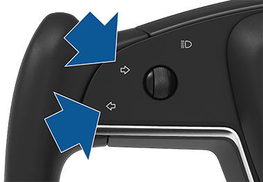 Closeup of left and right turn signals on steering yoke.