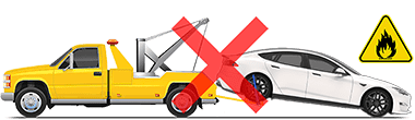 Model S being towed with front wheels on ground and rear wheels lifted by a tow truck and a red "X" to indicate this should not be performed.
