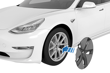 Wheel cover's Tesla "T" aligned with tire's valve stem with an arrow pointing from the cover to the tire