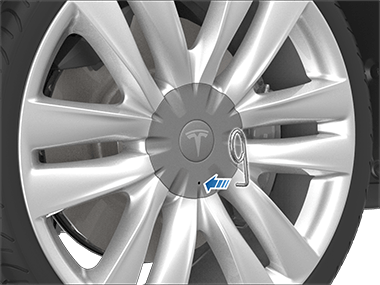 Arrow pointing from the lug nut tool to the hole on the lug nut cover