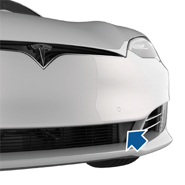 Arrow pointing to the vehicle's tow eye cover.