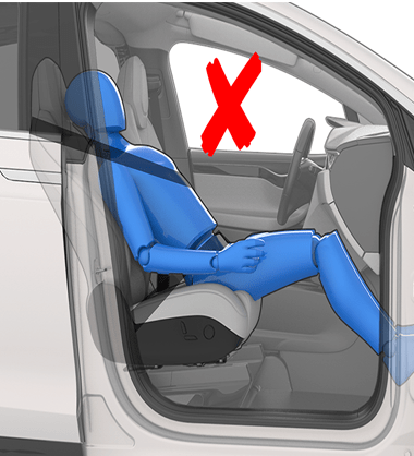 Person sitting in a car seat incorrectly with the backrest in a laying down position
