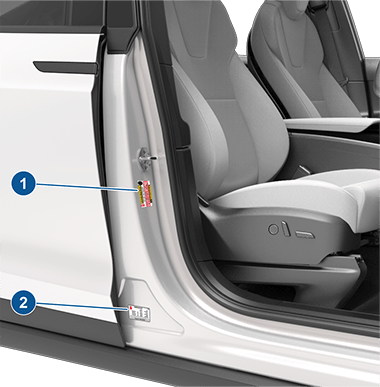 Two labels on center door pillar indicating how much weight the vehicle can carry