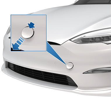 Front of vehicle with a zoombox and arrows indicating to press the top right corner of the tow eye cover to release it.