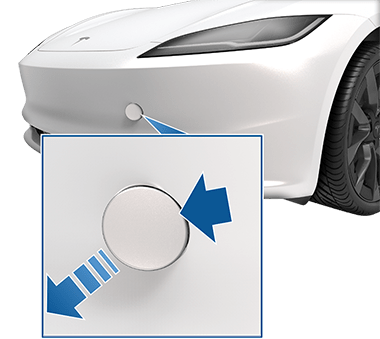 Front of vehicle with a zoombox and arrows indicating to press the top right corner of the tow eye cover to release it.