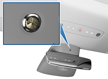 Zoombow with a camera lense, pointing to its location about the rear view mirror