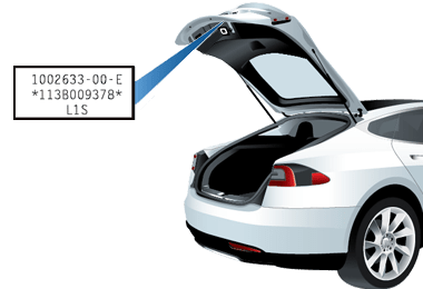 Rear trunk open with an arrow pointing to label on liftgate