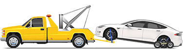 Model S being towed with front wheels lifted by a tow truck and rear wheels on dollies.
