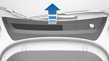 Front trunk access panel with blue arrow pointing up