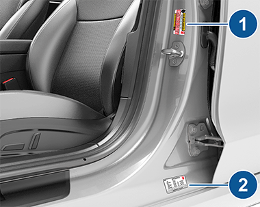 Two labels on center door pillar indicating how much weight the vehicle can carry